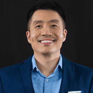 Calvin Woon, smiling, in a navy blazer